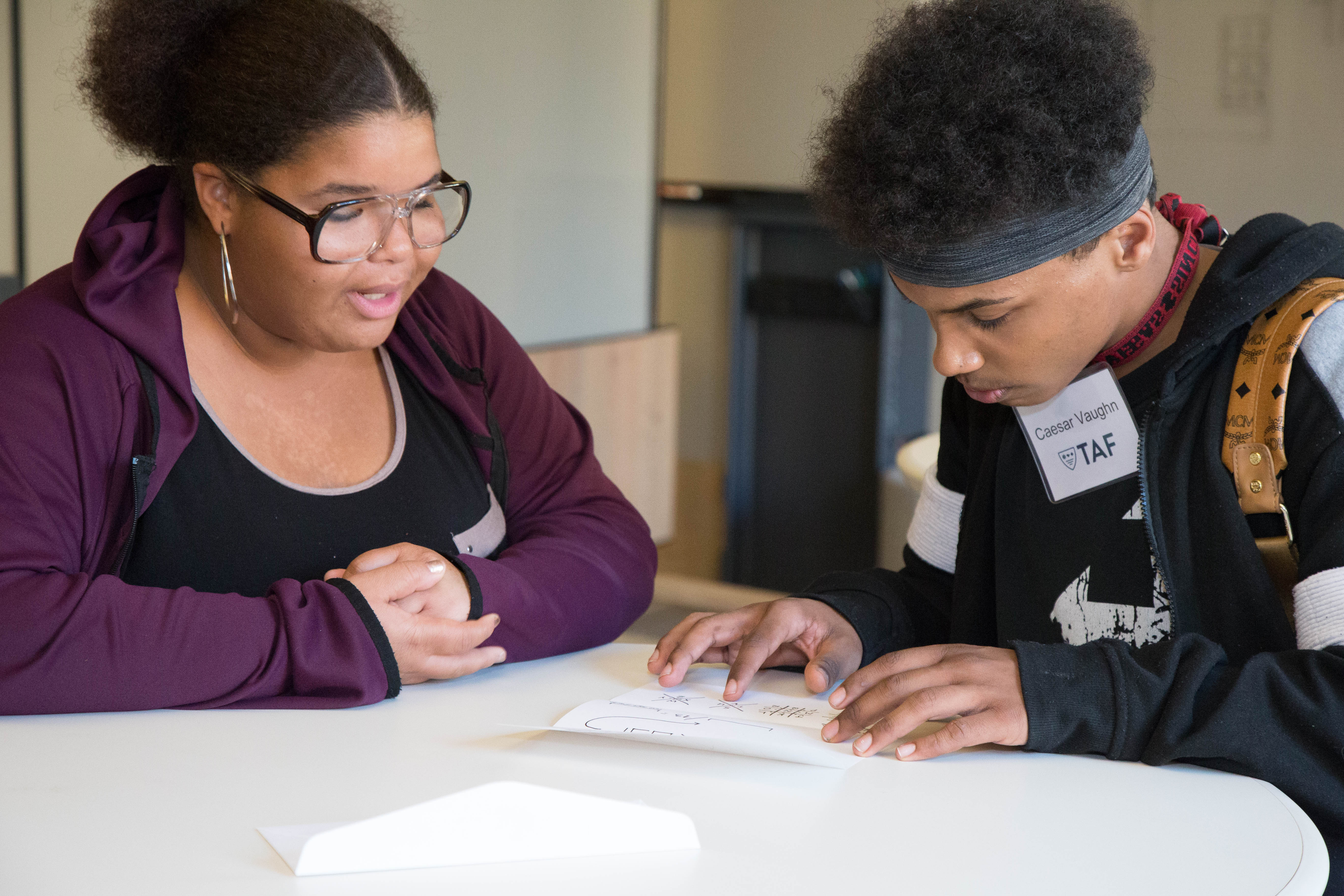 TAF students Loohche’ Brown and Caesar Vaughn participate in a scavenger-hunt-like game, led by Capital One Seattle associates. In the game, these and the other visiting TAF students had to use coding and logic to solve clues necessary to unlock a large metal safe.