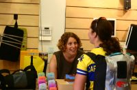 A cheerful Sunga helps a customer with their order at the Seattle Tom Bihn store