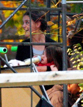 Suri Cruise drinks from a bottle in New York