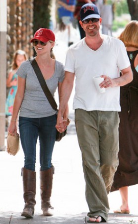 Reese Witherspoon and Jim Toth holding hands