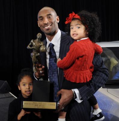 kobe bryant draft. Caption: Kobe Bryant holding MVP Award with daughters; Gianna (R) and 