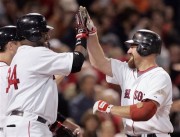 Youkilis is greeted by David Ortiz at home plate