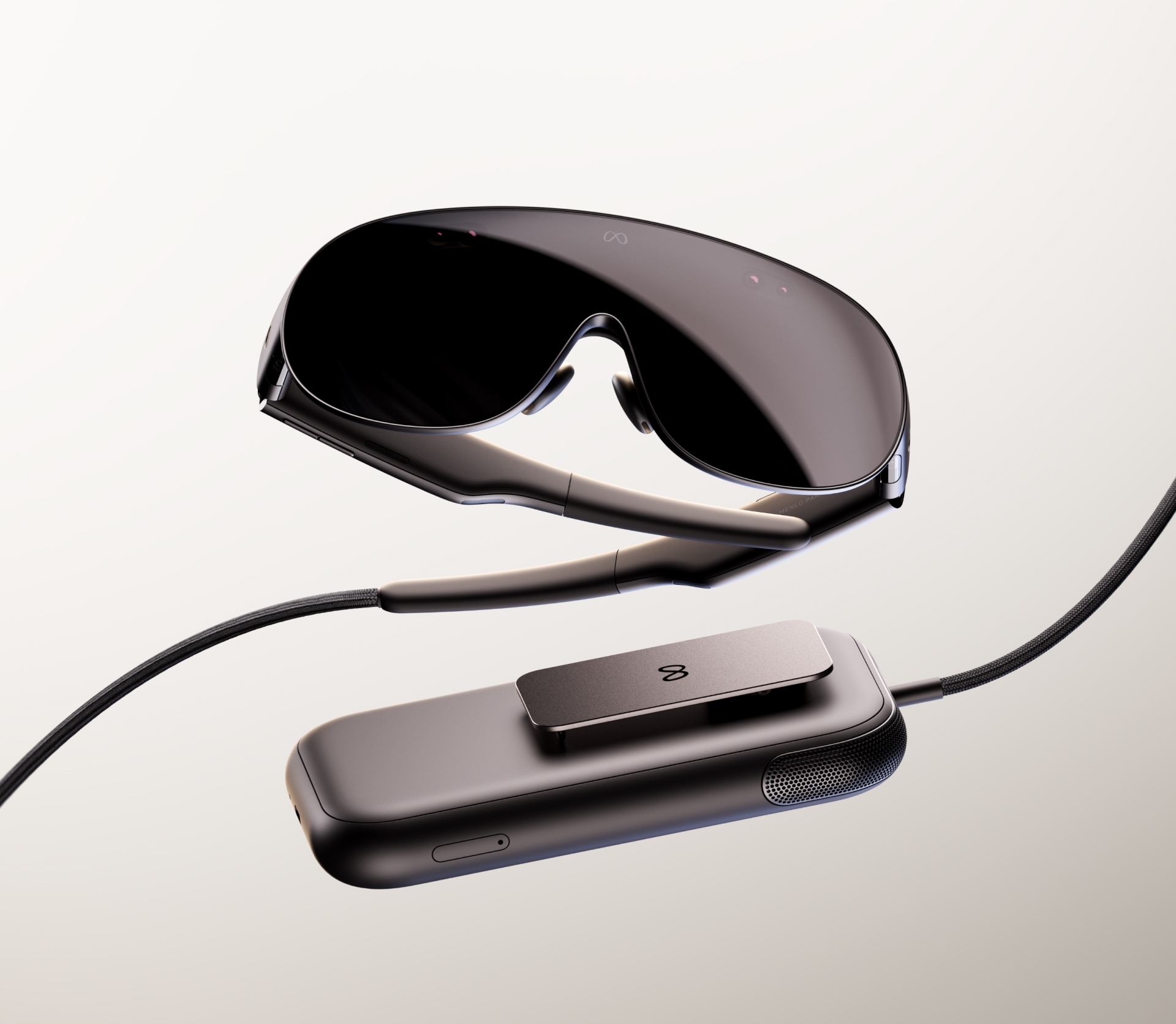 Meta VR Glasses shown above the clip-on compute puck they connect to by cable